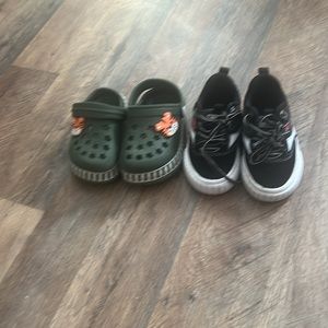 Slip on shoes with a tiger jibbitz and a pair of black and white levi’s